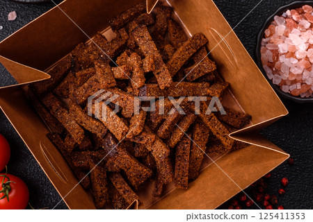 Crispy homemade brown bread crackers or croutons with seeds and grains 125411353