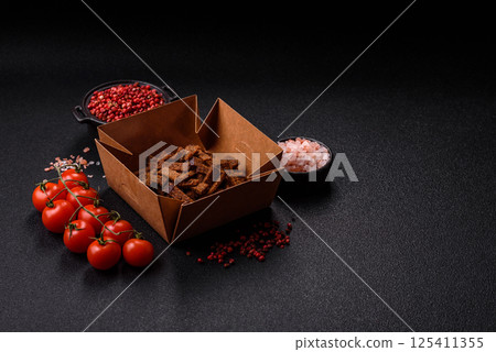 Crispy homemade brown bread crackers or croutons with seeds and grains 125411355