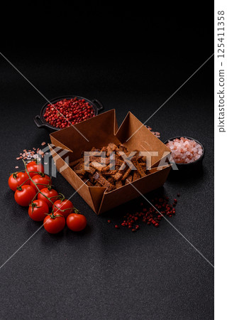 Crispy homemade brown bread crackers or croutons with seeds and grains 125411358