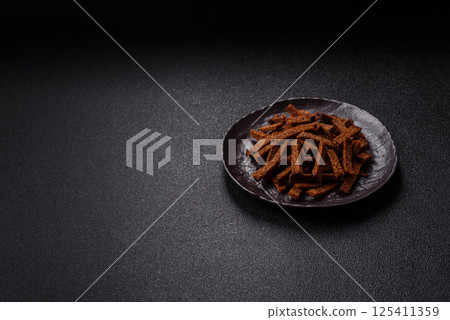 Crispy homemade brown bread crackers or croutons with seeds and grains 125411359