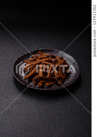 Crispy homemade brown bread crackers or croutons with seeds and grains 125411362