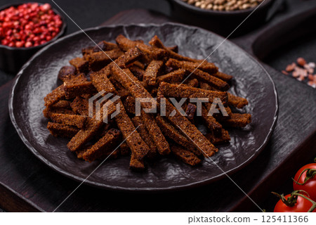 Crispy homemade brown bread crackers or croutons with seeds and grains Crispy homemade brown bread crackers or croutons with seeds and grains 125411366