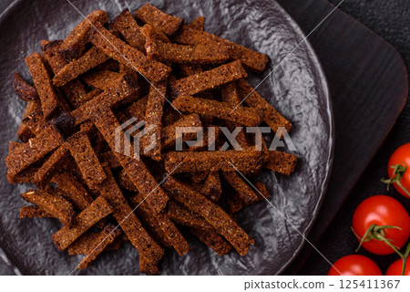 Crispy homemade brown bread crackers or croutons with seeds and grains Crispy homemade brown bread crackers or croutons with seeds and grains 125411367