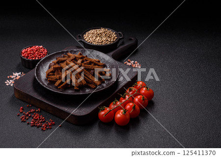 Crispy homemade brown bread crackers or croutons with seeds and grains 125411370