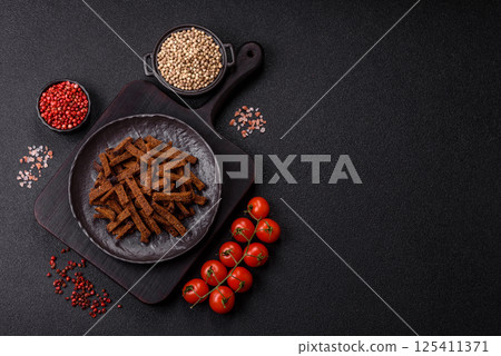 Crispy homemade brown bread crackers or croutons with seeds and grains 125411371