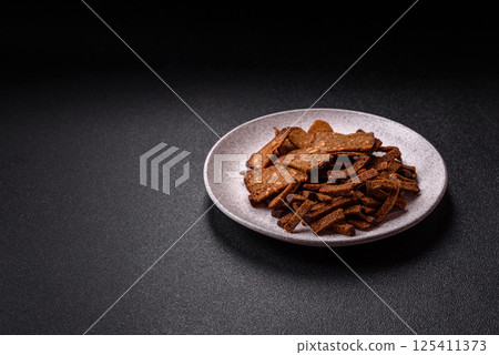 Crispy homemade brown bread crackers or croutons with seeds and grains Crispy homemade brown bread crackers or croutons with seeds and grains 125411373