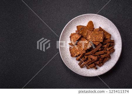 Crispy homemade brown bread crackers or croutons with seeds and grains Crispy homemade brown bread crackers or croutons with seeds and grains 125411374