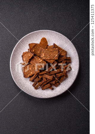 Crispy homemade brown bread crackers or croutons with seeds and grains Crispy homemade brown bread crackers or croutons with seeds and grains 125411375