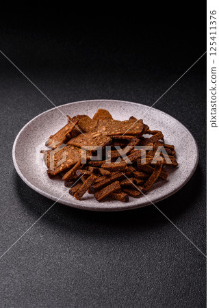Crispy homemade brown bread crackers or croutons with seeds and grains Crispy homemade brown bread crackers or croutons with seeds and grains 125411376