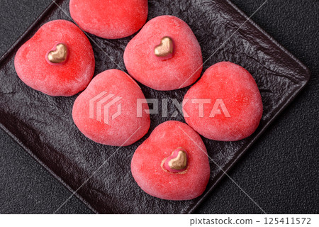Delicious sweet mochi in the shape of red hearts 125411572