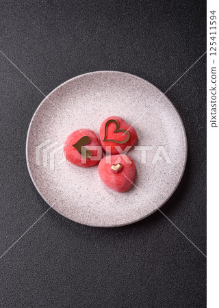 Delicious sweet mochi in the shape of red hearts 125411594