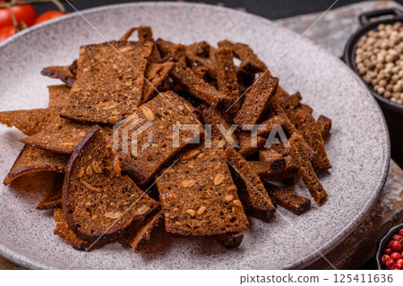 Crispy homemade brown bread crackers or croutons with seeds and grains 125411636