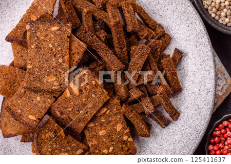 Crispy homemade brown bread crackers or croutons with seeds and grains 125411637