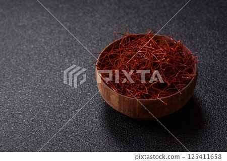 Red thin hot chili threads on a dark background Red thin hot chili threads on a dark background 125411658
