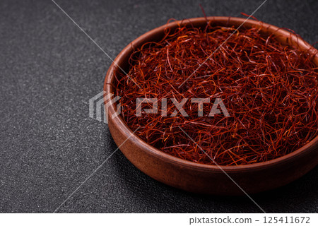 Red thin hot chili threads on a dark background Red thin hot chili threads on a dark background 125411672