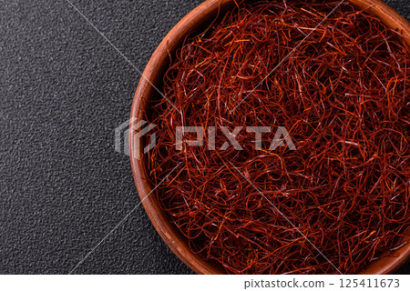 Red thin hot chili threads on a dark background Red thin hot chili threads on a dark background 125411673