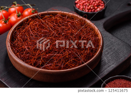 Red thin hot chili threads on a dark background Red thin hot chili threads on a dark background 125411675