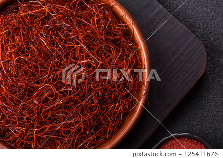 Red thin hot chili threads on a dark background 125411676
