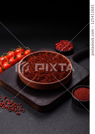 Red thin hot chili threads on a dark background Red thin hot chili threads on a dark background 125411681