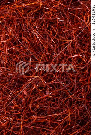 Red thin hot chili threads on a dark background Red thin hot chili threads on a dark background 125411683