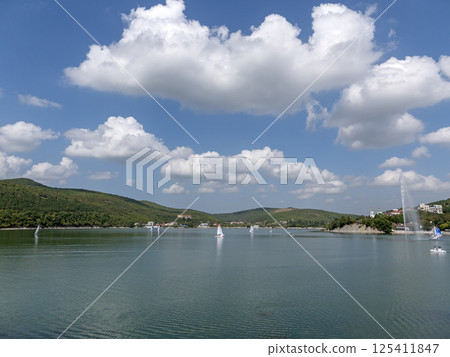 Abrau Durso, Russia 28 August 2024: Panoramic view of the lake Abrau-Durso with sailboats on a sunny day Abrau Durso, Russia 28 August 2024: Panoramic view of the lake Abrau-Durso with sailboats on a sunny day 125411847