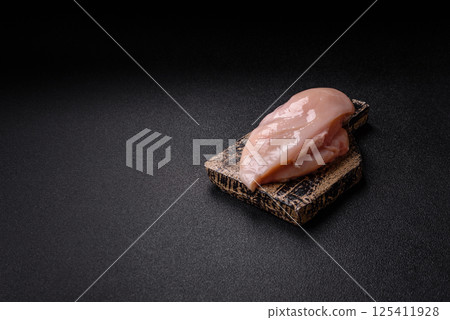 Raw chicken or turkey fillet with salt, spices and herbs Raw chicken or turkey fillet with salt, spices and herbs 125411928