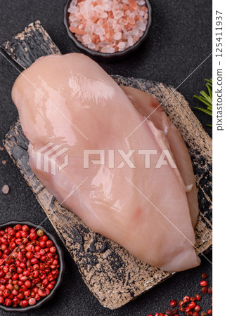 Raw chicken or turkey fillet with salt, spices and herbs Raw chicken or turkey fillet with salt, spices and herbs 125411937