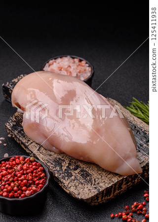 Raw chicken or turkey fillet with salt, spices and herbs Raw chicken or turkey fillet with salt, spices and herbs 125411938