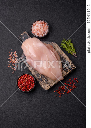 Raw chicken or turkey fillet with salt, spices and herbs Raw chicken or turkey fillet with salt, spices and herbs 125411941