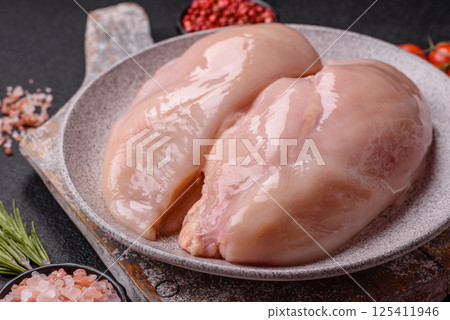 Raw chicken or turkey fillet with salt, spices and herbs 125411946
