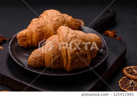 Sweet crispy croissants with chocolate filling 125411993