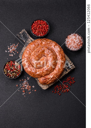 Delicious homemade sausage in the shape of a snail or spiral 125412066