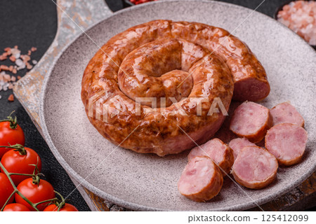 Delicious homemade sausage in the shape of a snail or spiral Delicious homemade sausage in the shape of a snail or spiral 125412099