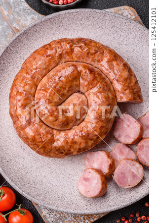 Delicious homemade sausage in the shape of a snail or spiral 125412101