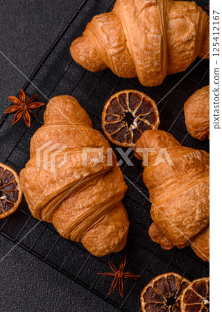 Sweet crispy croissants with chocolate filling 125412167