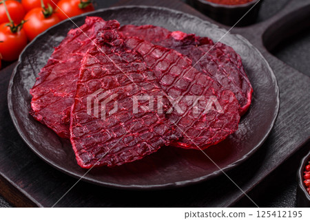 Dried beef slices, jerky, with cherry or plum flavor, salt and spices Dried beef slices, jerky, with cherry or plum flavor, salt and spices 125412195