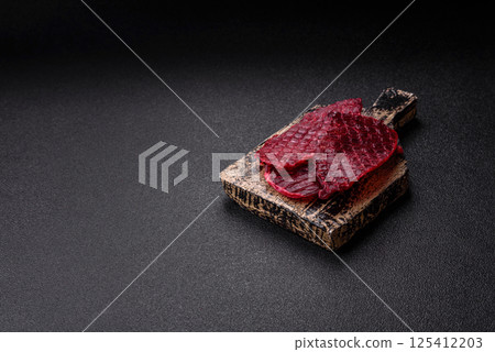 Dried beef slices, jerky, with cherry or plum flavor, salt and spices 125412203