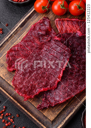 Dried beef slices, jerky, with cherry or plum flavor, salt and spices 125412223