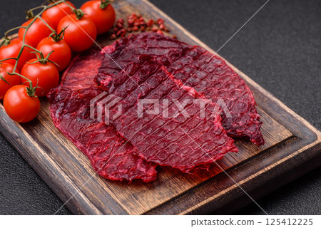 Dried beef slices, jerky, with cherry or plum flavor, salt and spices Dried beef slices, jerky, with cherry or plum flavor, salt and spices 125412225