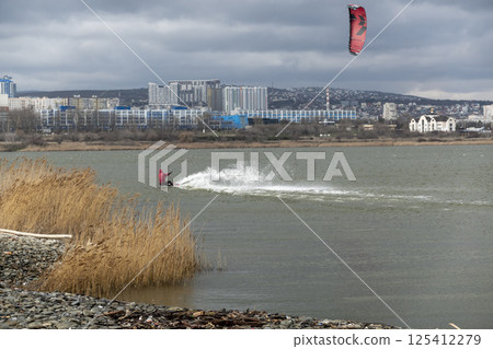 Novorossiysk, Russia 08.18.2024 kite surfer rides and jumps the waves the black sea 125412279