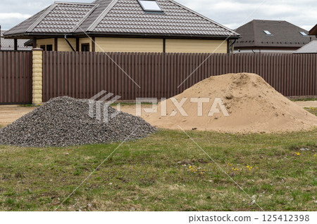 Construction materials sand and gravel preparing a foundation for building a house Construction materials sand and gravel preparing a foundation for building a house 125412398