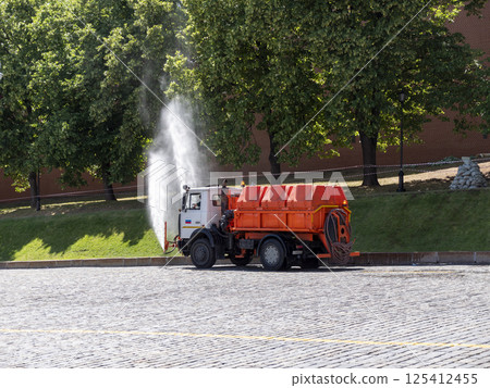 Moscow, Russia May 14, 2024: water-sprinkling machine on Red Square on a hot summer day 125412455