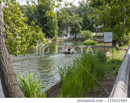 Moscow, Russia May 14, 2024: a walk on catamaran on a summer day. Vacationers at the lake Gorky Park Moscow, Russia May 14, 2024: a walk on catamaran on a summer day. Vacationers at the lake Gorky Park 125412469