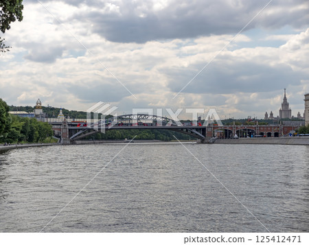 Moscow, Russia May 14, 2024: View of the Moscow river embakment, Andreevsky bridge and cruise ships Moscow, Russia May 14, 2024: View of the Moscow river embakment, Andreevsky bridge and cruise ships 125412471
