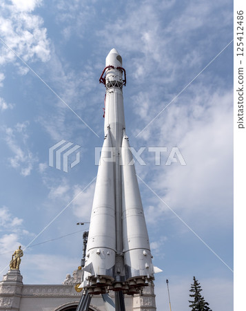 MOSCOW, RUSSIA - APRIL 23, 2024: Booster rocket Vostok at the pavilion Space on VDNCH. Walking Muscovites and tourists 125412486