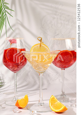 Flyer with various alcoholic drinks with tropical fruits, margarita, aperol sprits cocktail with slices of blood orange, grapefruit, with rum from tequila, rum, vodka and ice. Summer party concept, 125412536