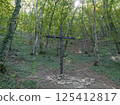 Novorossiysk, Russia 28 August 2024 Metal cross from fragments in the forest 125412817