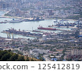 Panoramic view of Novorossiysk City and Tsemess Bay at sunrise. Morning cityscape of large port at Black Sea coast in Russia 125412819