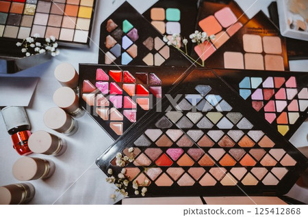 Various Makeup Palettes with Lipsticks and Flowers 125412868