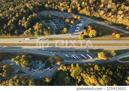 Large truck stop with resting area near busy American interstate freeway. Parking place during big rig interstate travel 125413031